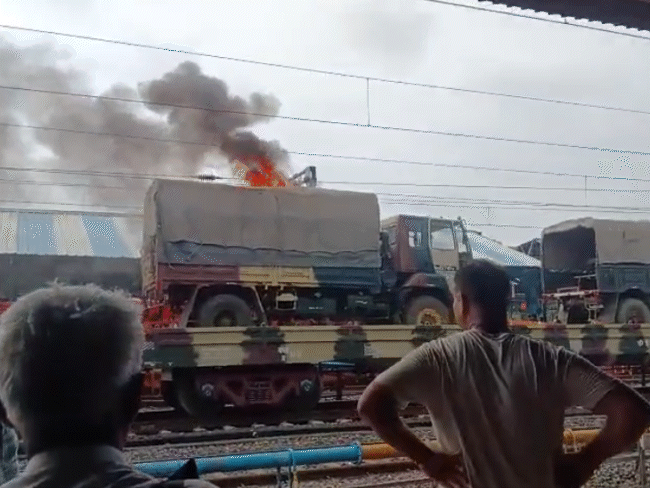 उज्जैन में मालगाड़ी में लोड सेना के ट्रक में आग:हाइटेंशन लाइन से ट्रक का कवर जला; RPF और रेलवे की टीमों ने काबू पाया