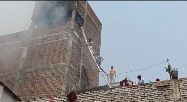 आग बुझाने में जुटे स्थानीय लोग।