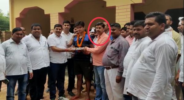 क्षेत्र पंचायत सदस्य को अपने पक्ष में वोट देने के लिए उपहार देते हुए प्रत्याशी विजय तोमर