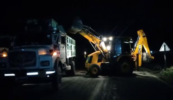 हादसे के बाद बजरी ट्रक में लोड करती JCB