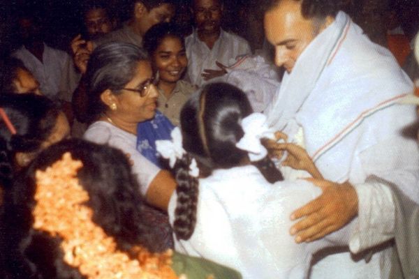 आत्मघाती हमले से पहले खींची गई राजीव गांधी की आखिरी तस्वीर। स्कूली बच्ची के पीछे नारंगी फूल सिर में लगाकर आगे बढ़ रही धनु ने ही फूलों का हार पहनाकर विस्फोट किया था।