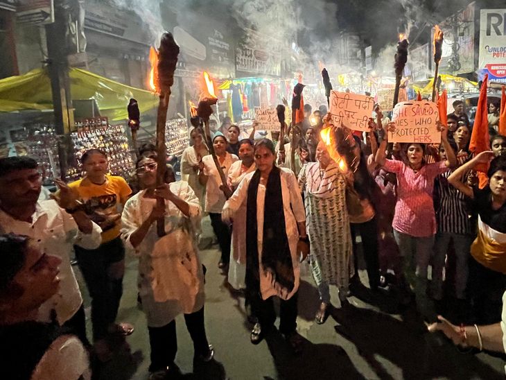A torchlight procession was taken out in protest against the brutality ...