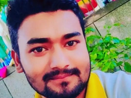 A young man died after being crushed under a tractor-trolley