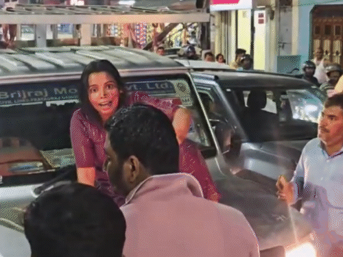 High voltage drama of a woman, she sat on the bonnet