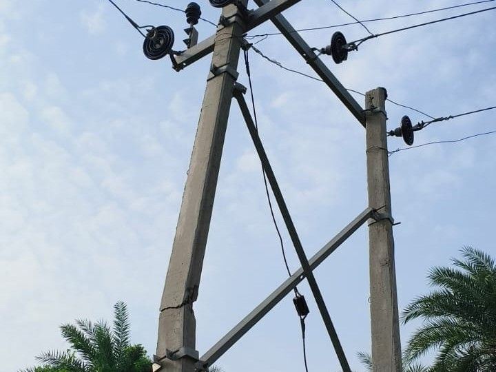 Damaged electricity pole poses a threat on the road