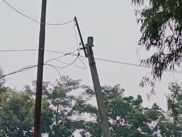 A tilted electric pole on the highway poses a danger