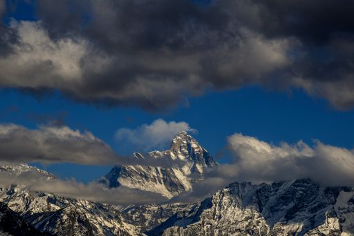 The Nanda Devi mountain range, with its jagged ice-covered peaks, is surrounded by mountains on all sides.