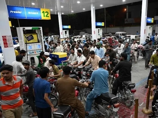 People wait in line for gasoline at a gas station in Islamabad. - Bhaskari English