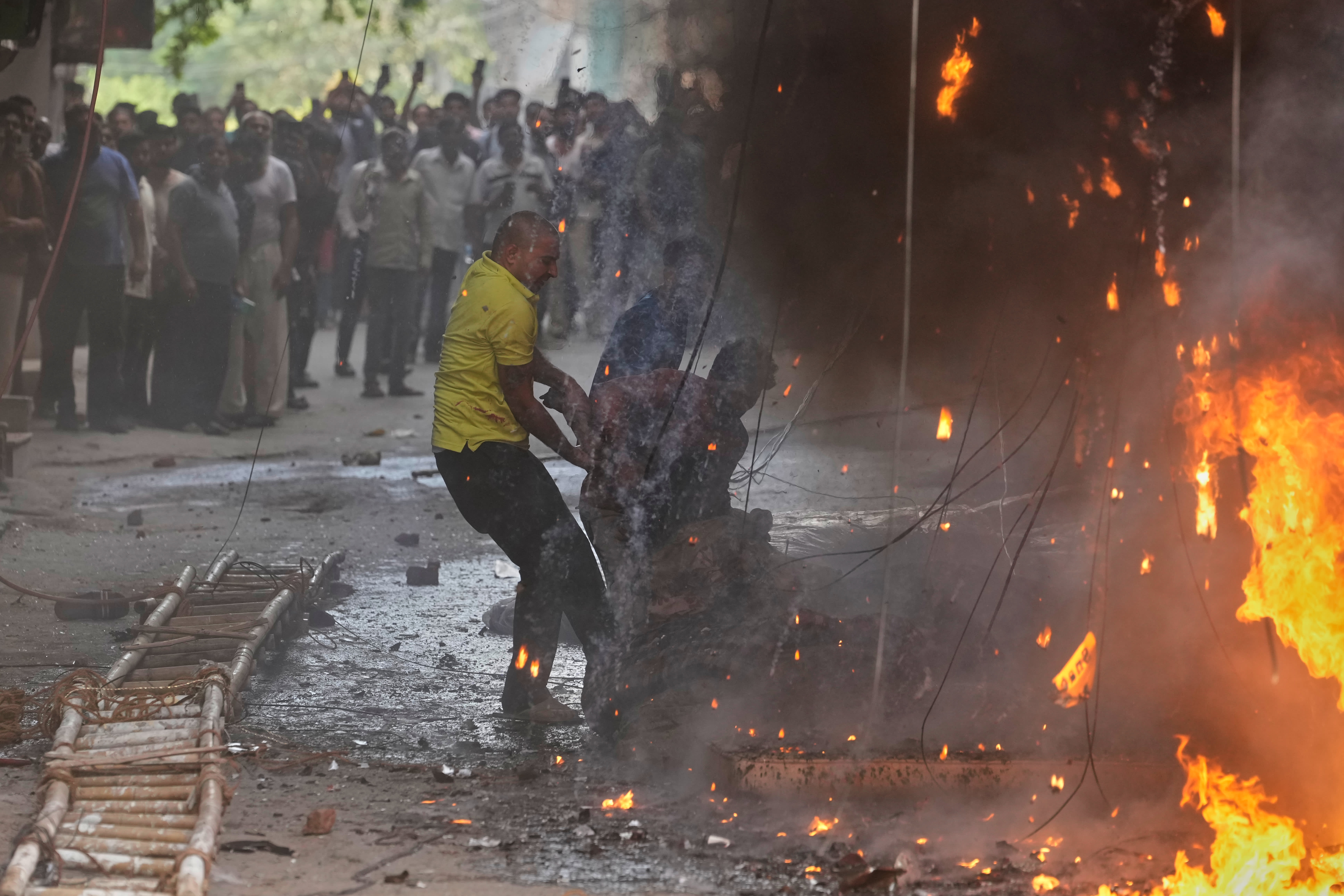 Locals helped rescue a foreign national from a hotel fire in New Delhi on 3 June.