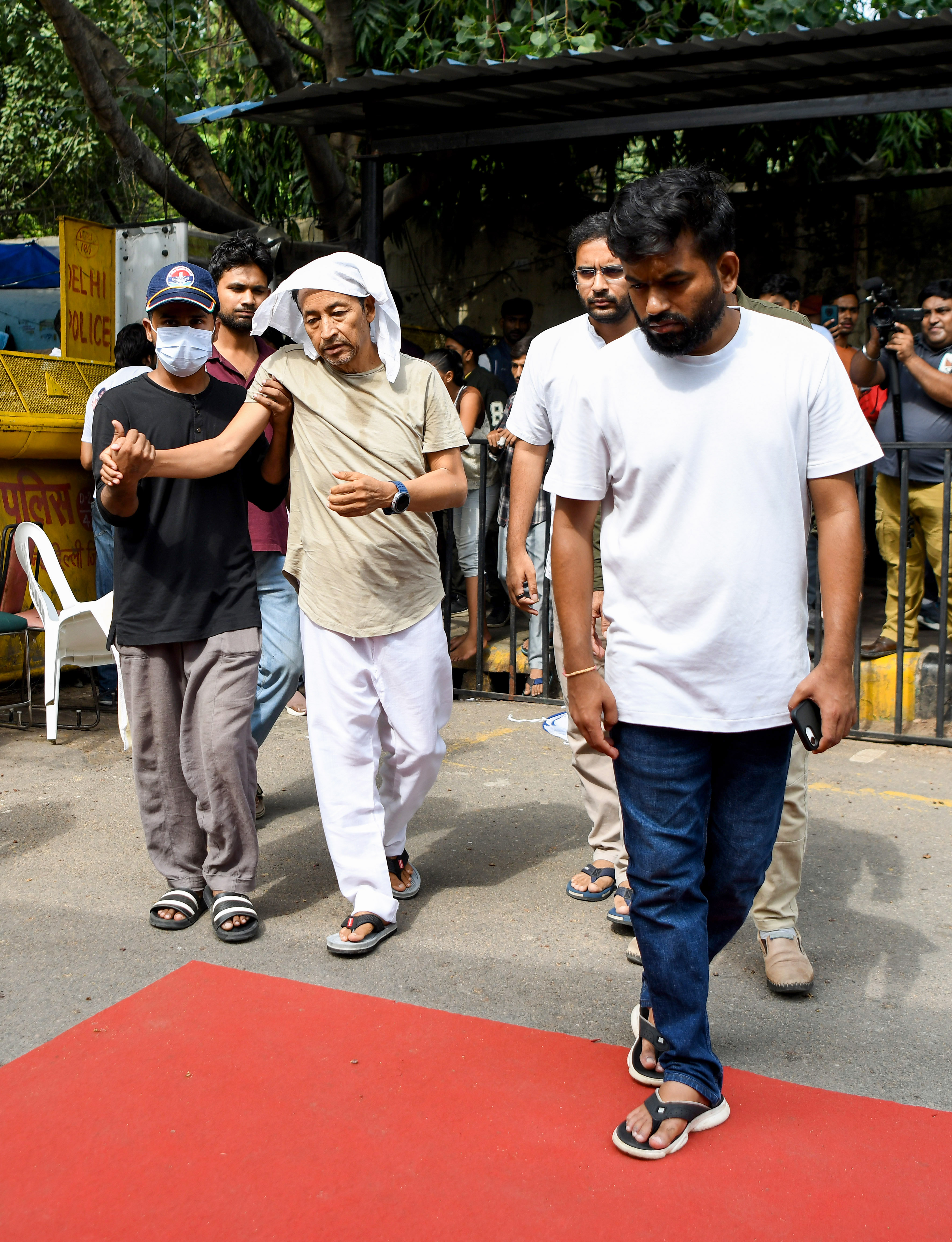 Environmentalist Sonam Wangchuk walks with support on the 18th day of his indefinite hunger strike during a protest at Jantar Mantar in New Delhi on 15 July, with CJP founder Abhijeet Dipke also present.