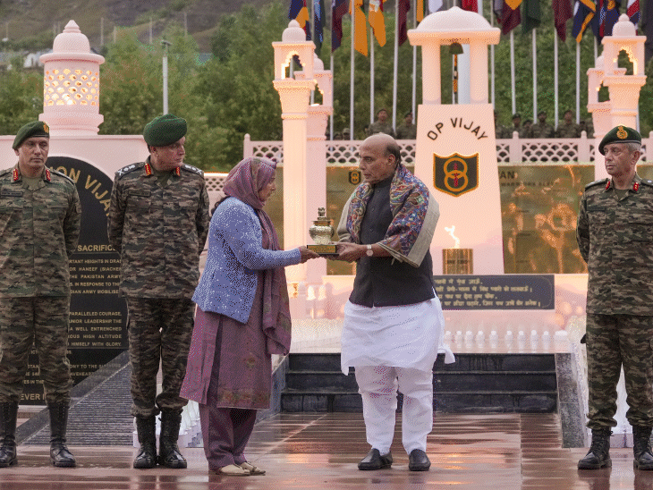 At the Kargil War Memorial in Dras on Saturday, Defense Minister Rajnath Singh presented a memento to the family members of a martyred soldier. - Bhaskar English