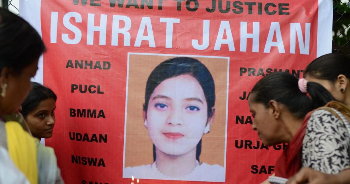 People hold candles in front of a banner bearing the portrait of Ishrat Jahan during a protest in Ahmedabad on 6 July, 2013 | AFP