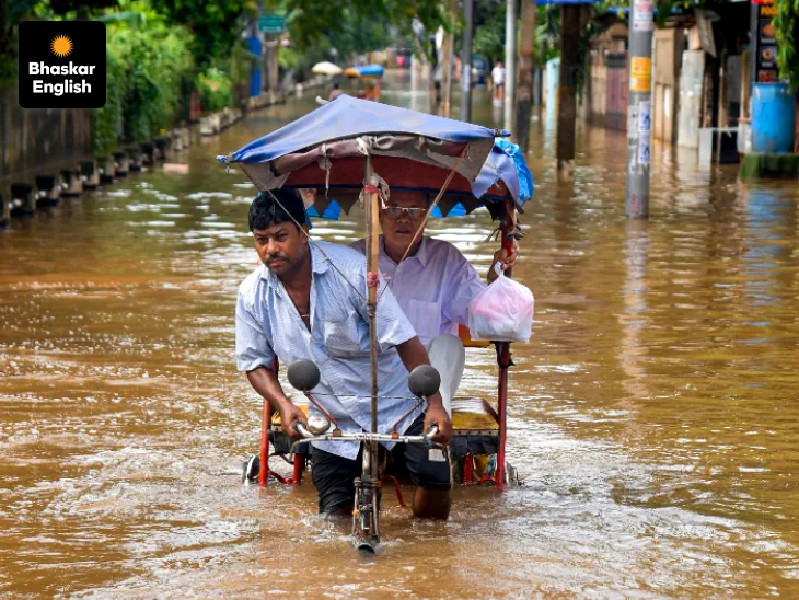 Life rolls on! A rickshaw puller navigates flooded roads after heavy rainfall in Guwahati. Photo: PTI