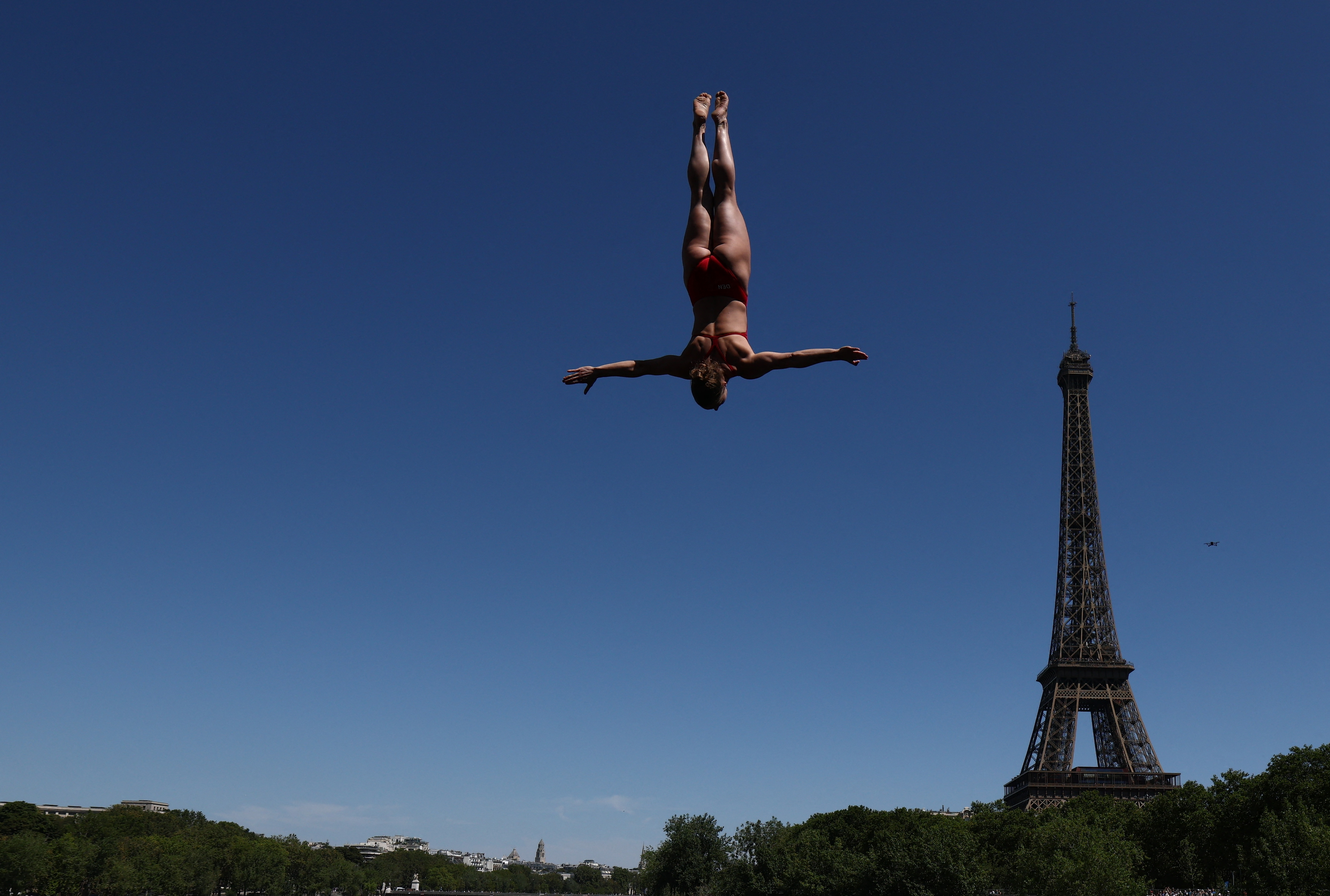 Where Sport Meets the Skyline: Denmark's Annika Bornebusch in action during round 1 of Women's 20m Platform as the Eiffel Tower is seen in the background (Photo: Reuters)