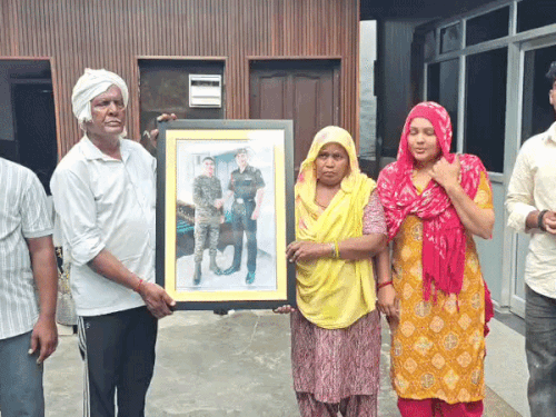 Family of Lance Naik Dinesh Sharma, martyred during Operation Sindoor, showing his photograph. - Bhaskar English