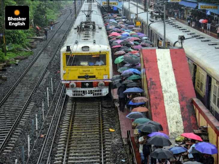 Monsoon Struggles: Commuters use umbrellas while boarding local trains amid heavy rainfall at Bidhannagar Road railway station in Kolkata.