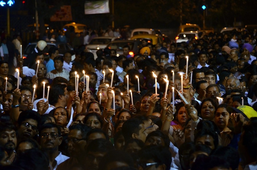 People pay their respects with a candlelight tribute to AMRI fire victims. The fire took the lives of 93 people.