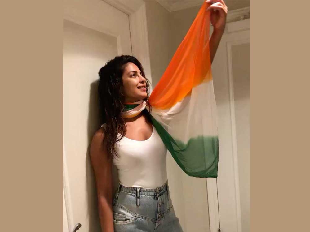 She wore a white top and jeans with a tricolour scarf around her neck.
