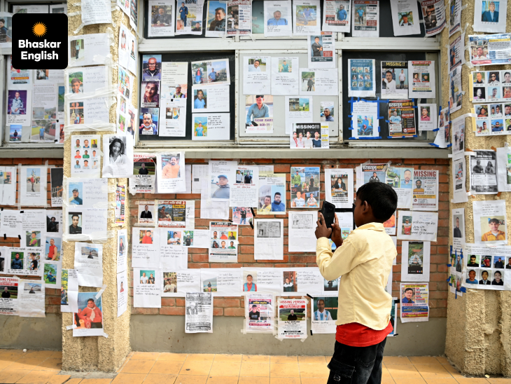Wall of Hope: A boy uses a mobile phone to take photos of missing and deceased people pasted on wall outside Tribhuvan University Teaching Hospital, following flash floods and a mudslide, in Kathmandu, Nepal (Photo Source: Reuters)