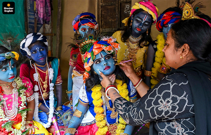 Little Krishna wins hearts: A woman applies makeup on a child dressed as Lord Krishna during a celebration on the eve of the ''Janmashtami'' festival. (Photo: PTI)