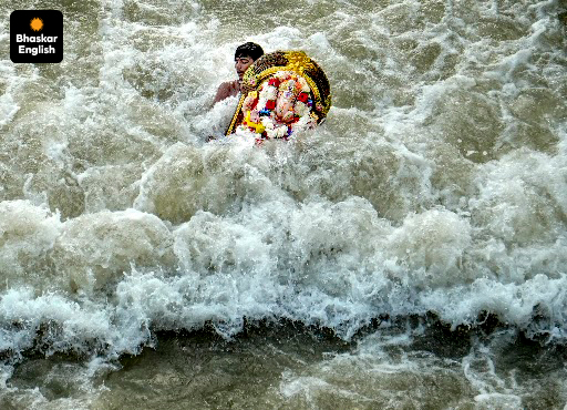 ‘Deep in Devotion’: A devotee immerses a Lord Ganesh idol in a canal on the outskirts of Amritsar during the Ganesh Chaturthi festival. (Photo: PTI)