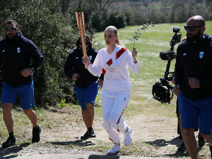 ग्रीस की शूटिंग चैम्पियन एना कोरकाकी मशाल लेकर दौड़ीं।