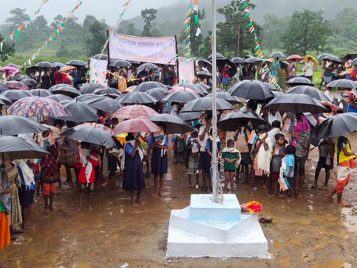 तस्वीर मारजुम गांव की है। इसमें गांव के छोटे-छोटे बच्चे भी चेहरों पर मास्क लगाकर छाता लिए खड़े दिखे।
