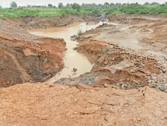 घोड़ाडोंगरी की बांसपुर पंचायत में तालाब फूटने से बह निकला पानी।