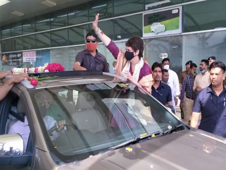 एयरपोर्ट से बाहर निकलने के बाद कार्यकर्ताओं का अभिवादन स्वीकार करती प्रियंका गांधी।