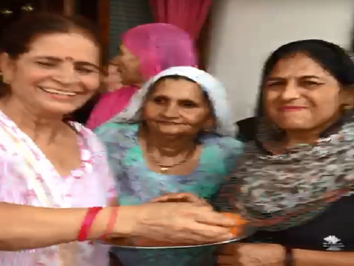 नीरज की जीत के बाद उनके घर में लड्डू बांटती महिलाएं।