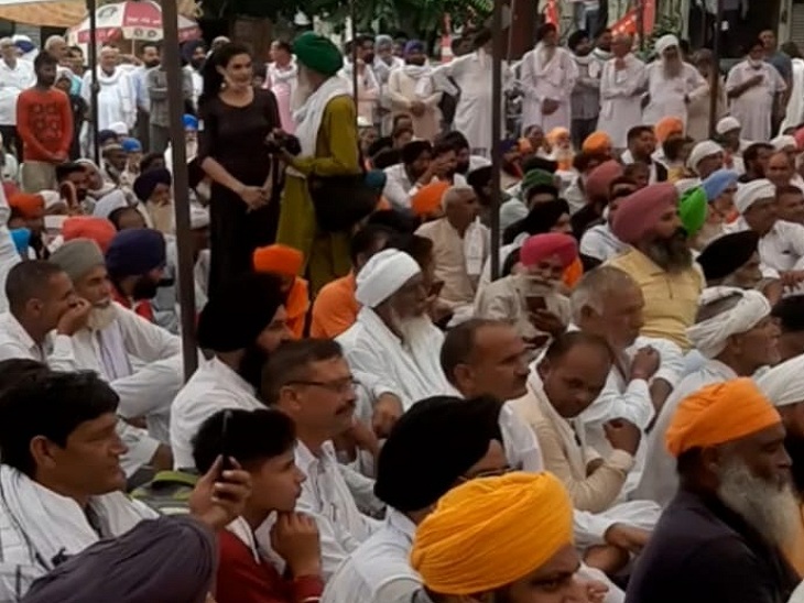 Farmers listening to their leaders at the protest site.