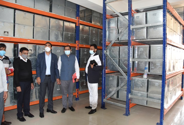 आधुनिक राजस्व रिकार्ड रूम को देखते हुए अधिकारी।