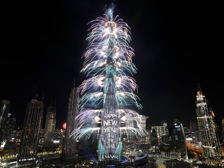Fireworks are fired over the world's tallest building Burj Khalifa during New Year's Eve in Dubai. During this the building was illuminated with 'Happy New Year' through laser light.