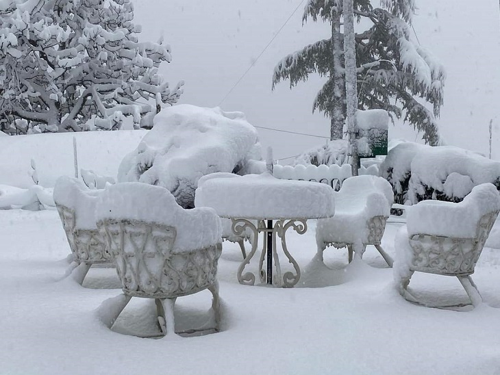 Chairs covered in snow outside Holi-Lodge in Shimla.