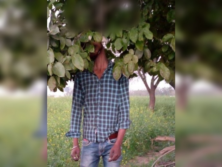dead body of a young man was found hanging from a tree in the field ...