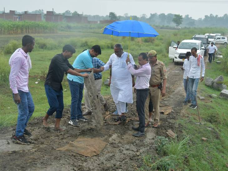 गाजियाबाद की इस तस्वीर में देख सकते हैं कि मंत्री को कीचड़ से बचाने के लिए उनके आगे बोरियां रखी जा रही हैं। - Dainik Bhaskar