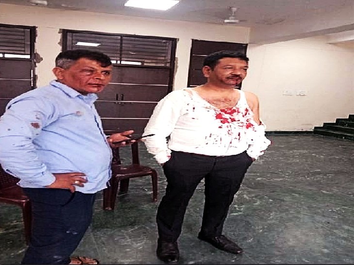 The injured contractor (in white shirt) and his driver in the assault incident.