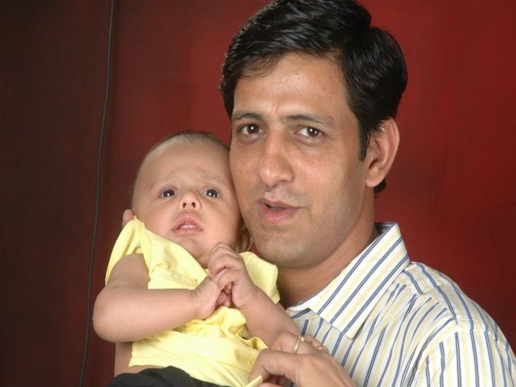 Bhargava caressing his son Sangh Mitra.