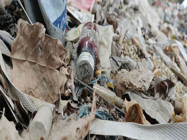 Maiden Company's syrup bottles lying in the open outside the company.