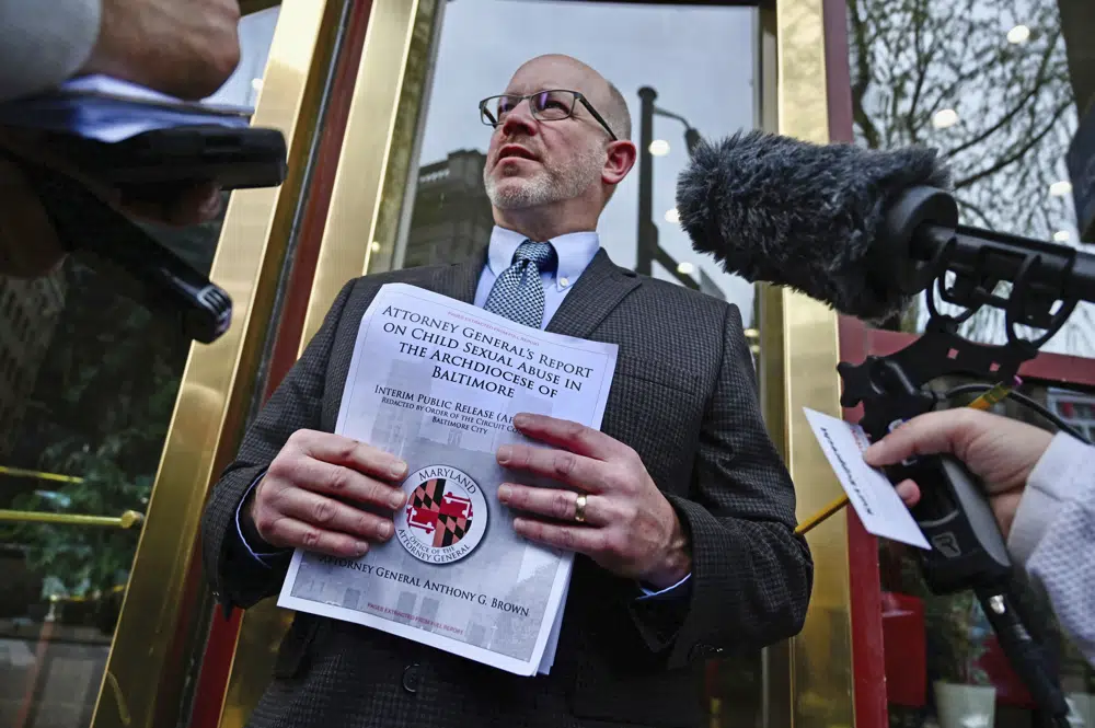 The picture is of Kurt Ruprecht who was sexually abused as a child.  On Thursday, he talked to the media about this.  The report of the Attorney General is visible in his hand.