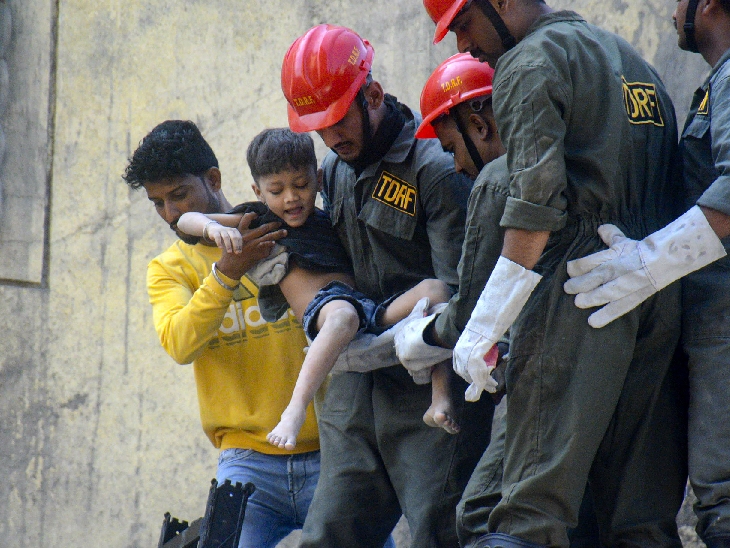 Rescue workers safely pulled a child out of the rubble.