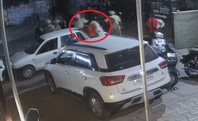 महिला को खिंच कर गाड़ी के पीछे ले जाते पुलिस कर्मचारी। - Dainik Bhaskar