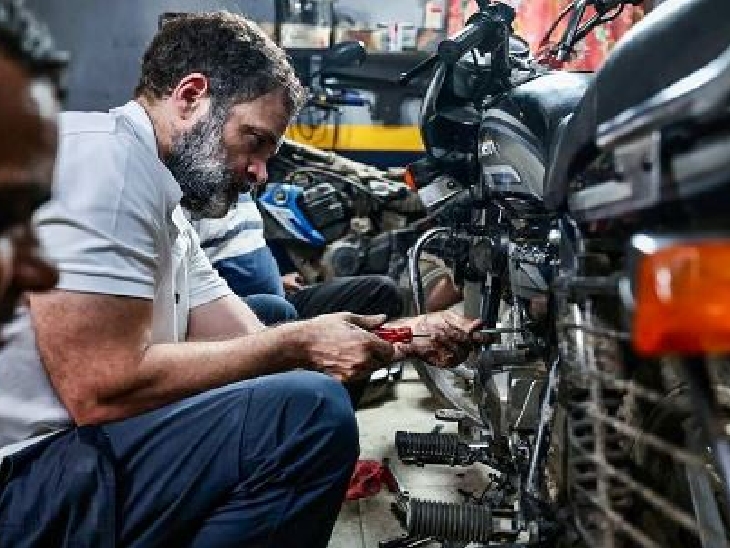 Rahul is putting some part in the bike.