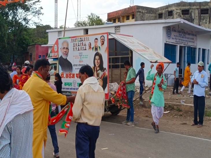 श्रद्धालुओं को भाजपा का गमछा पहना रहे थे समर्थक