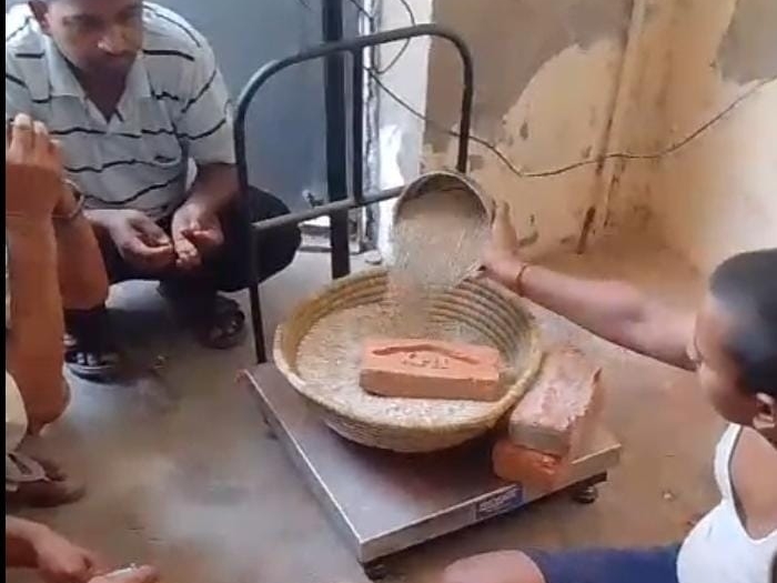 The ration dealer was seen weighing ration by placing three bricks ...