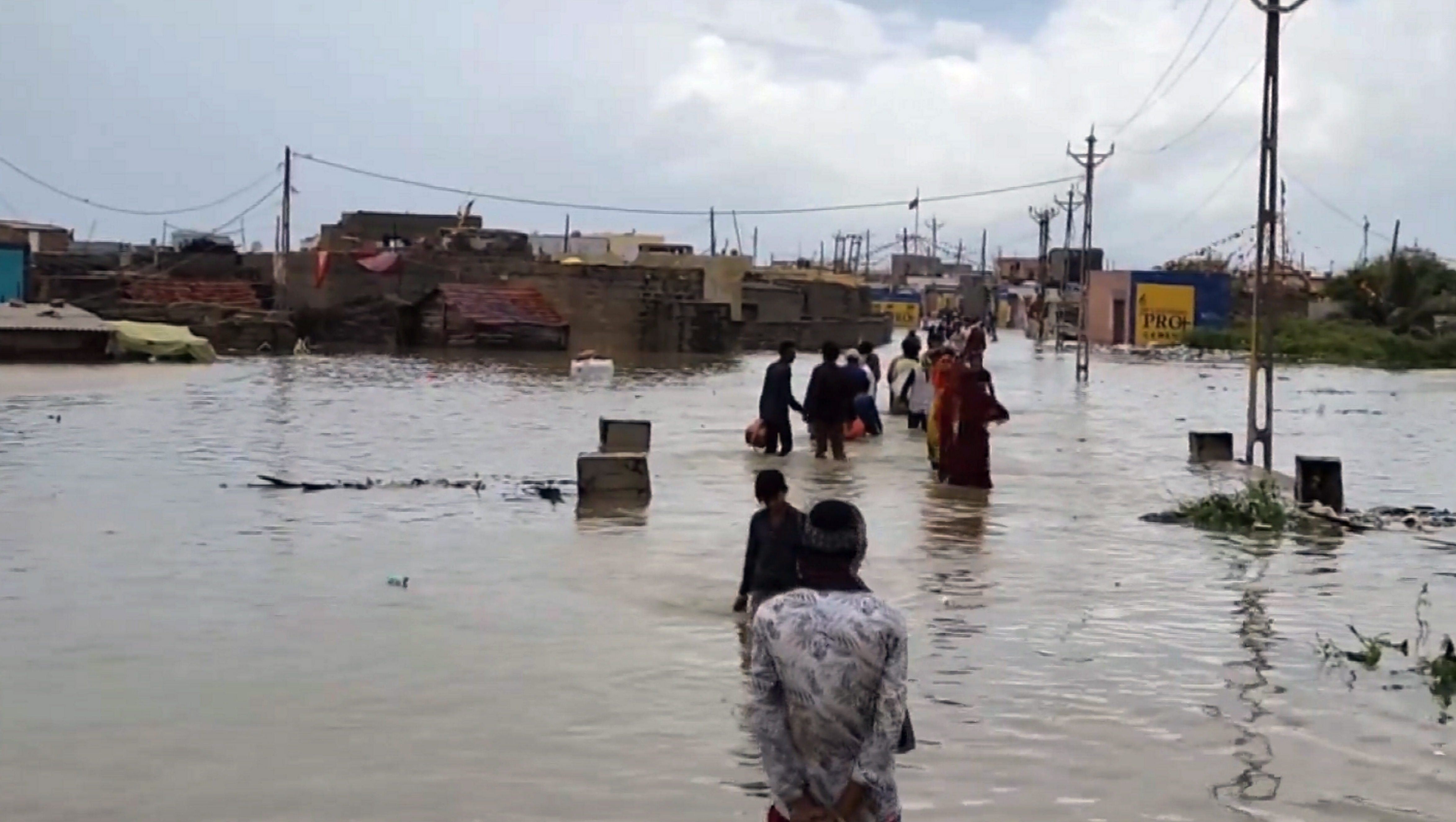 Roads were flooded after heavy rains in Dwarka, Uttar Pradesh on Saturday. People wading through the water.