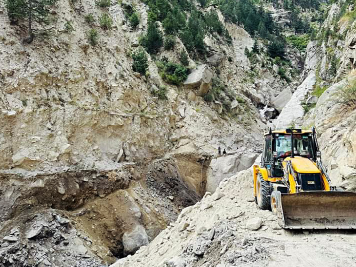 Repair work is going on on the road damaged after cloudburst in Rispa village of Kinnaur.