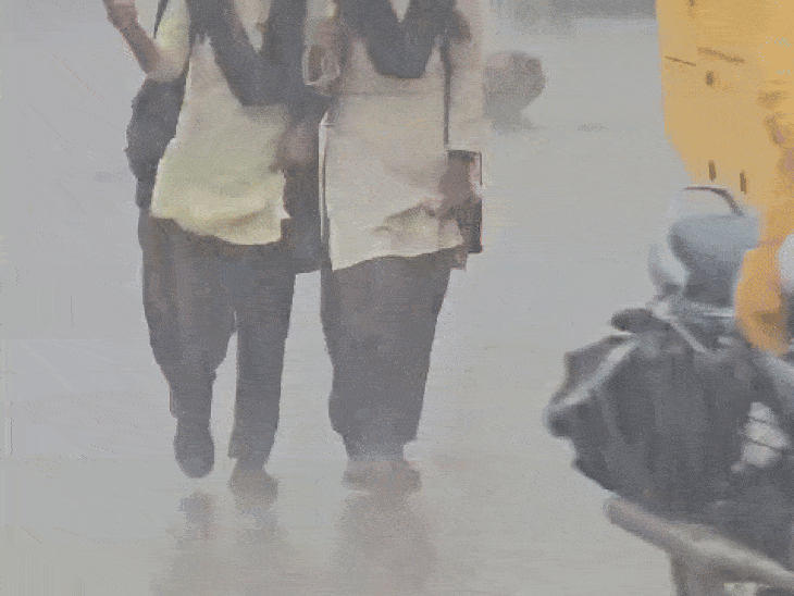 School girls going to school in the rain in Shajapur, Madhya Pradesh.