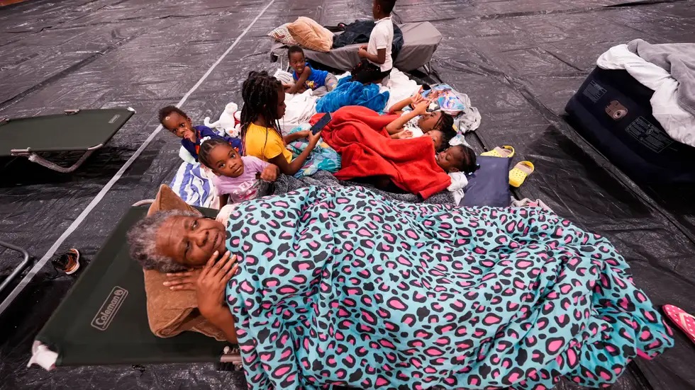 In Tallahassee, an elderly woman along with her grandchildren were rescued and shifted to a shelter built in a school.