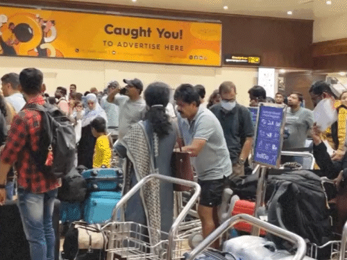 Passengers waiting for check-in in front of IndiGo counter at Kochi Airport.